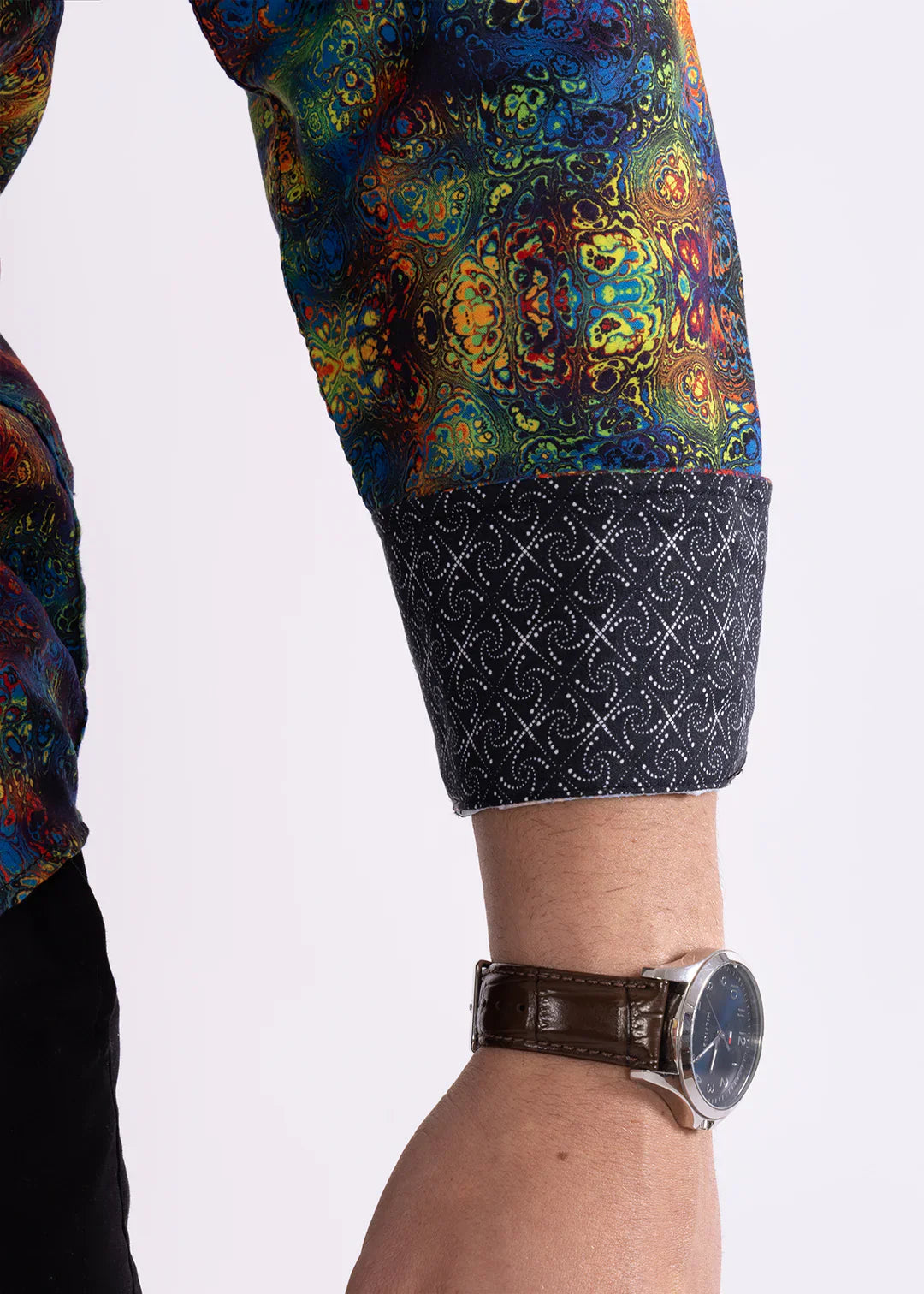 Multicolor patterned l/s shirt with vibrant mandala sleeve and dark navy cuff featuring white geometric design