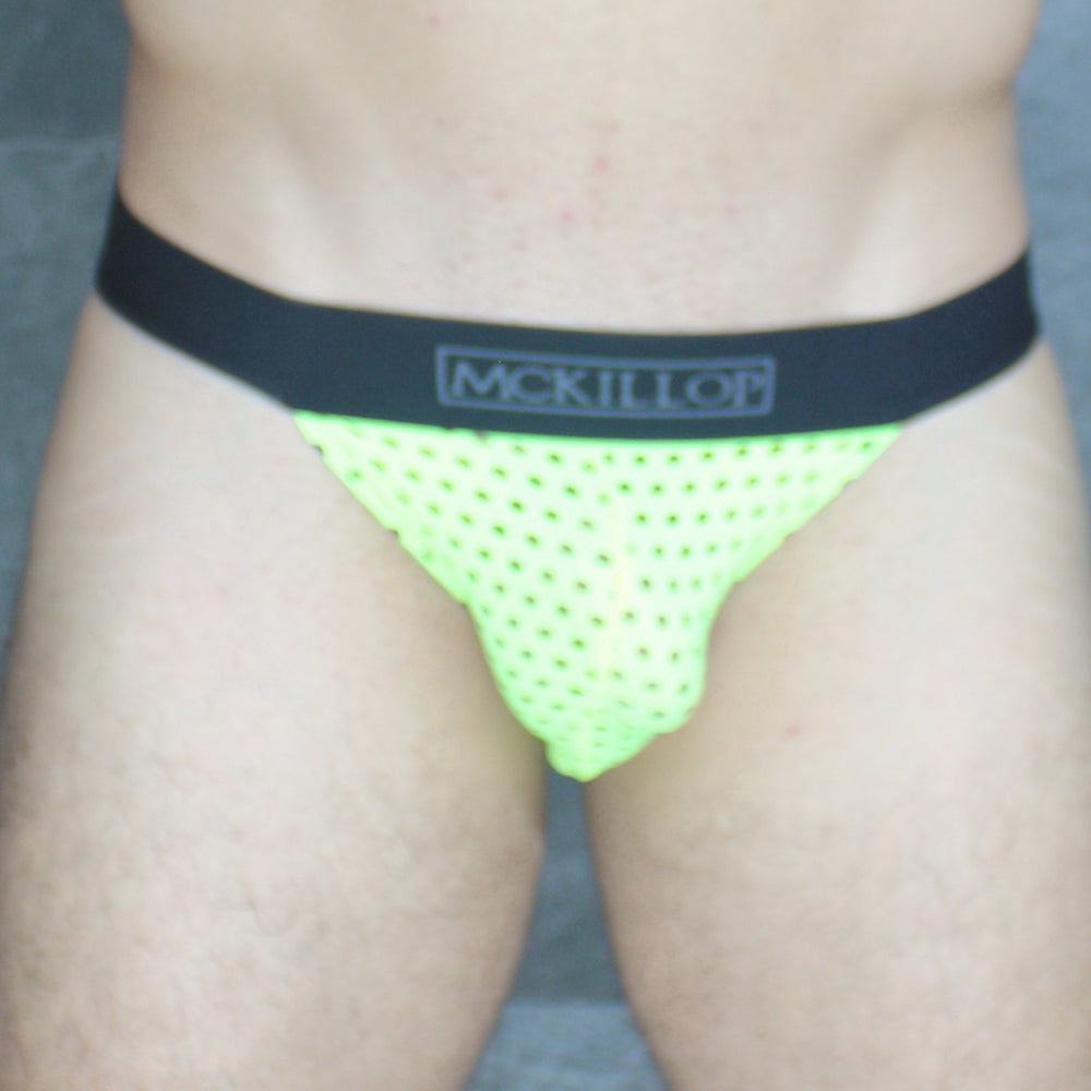 Neon green perforated mesh mckillop wwhq tanga brief with black elastic waistband featuring mckillor logo in lycra