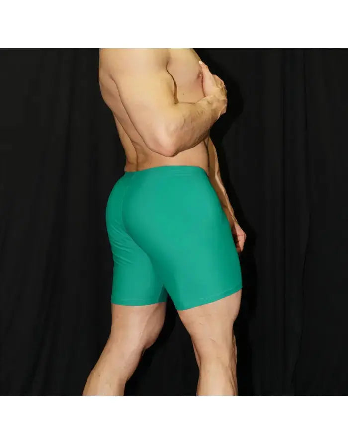 Men's green compression shorts by Arroyman featuring a snug fit and smooth fabric shown from the side on a model.