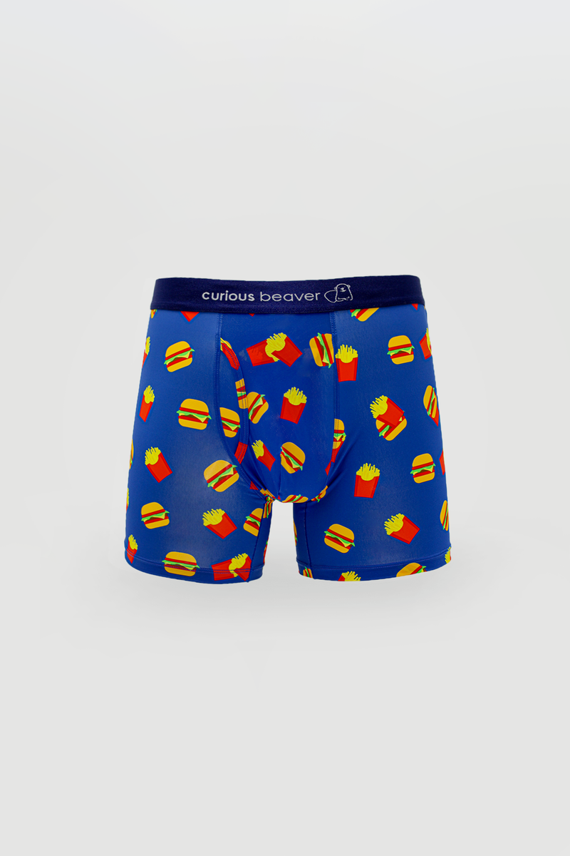 Mens blue boxer briefs with yellow burger and red fries pattern on vibrant fabric featuring curious beaver logo waistband