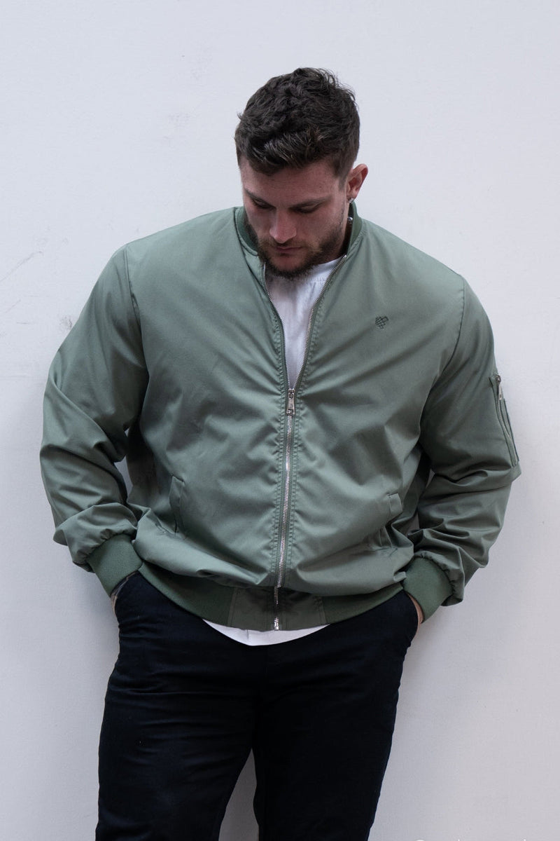 Men’s premium olive bomber jacket with subtle logo on left chest and ribbed cuffs in durable fabric