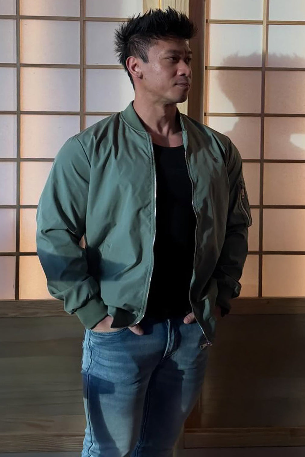 Men’s premium bomber jacket in olive green with a matte finish and subtle stitching details visible on front