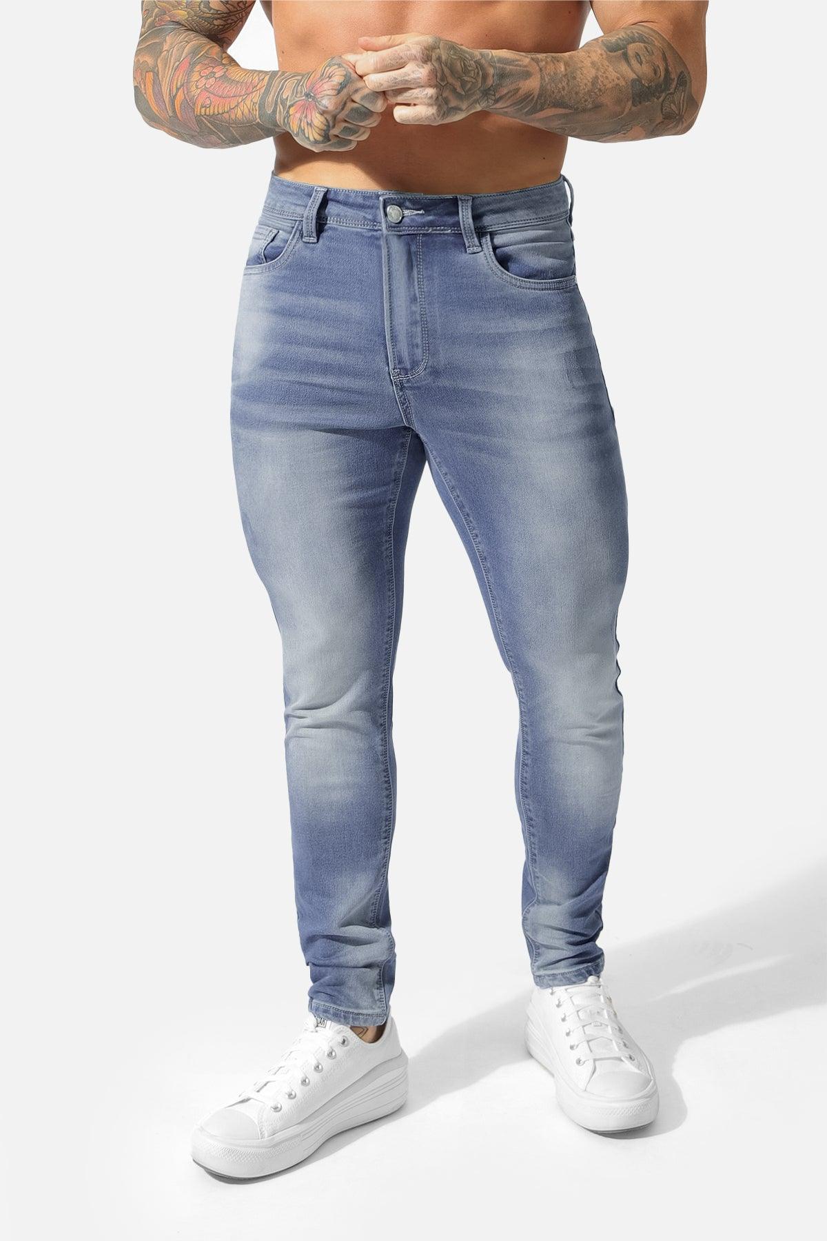 Men’s premium fitted stretchy jeans in faded blue light-wash denim with slim fit and classic five-pocket design