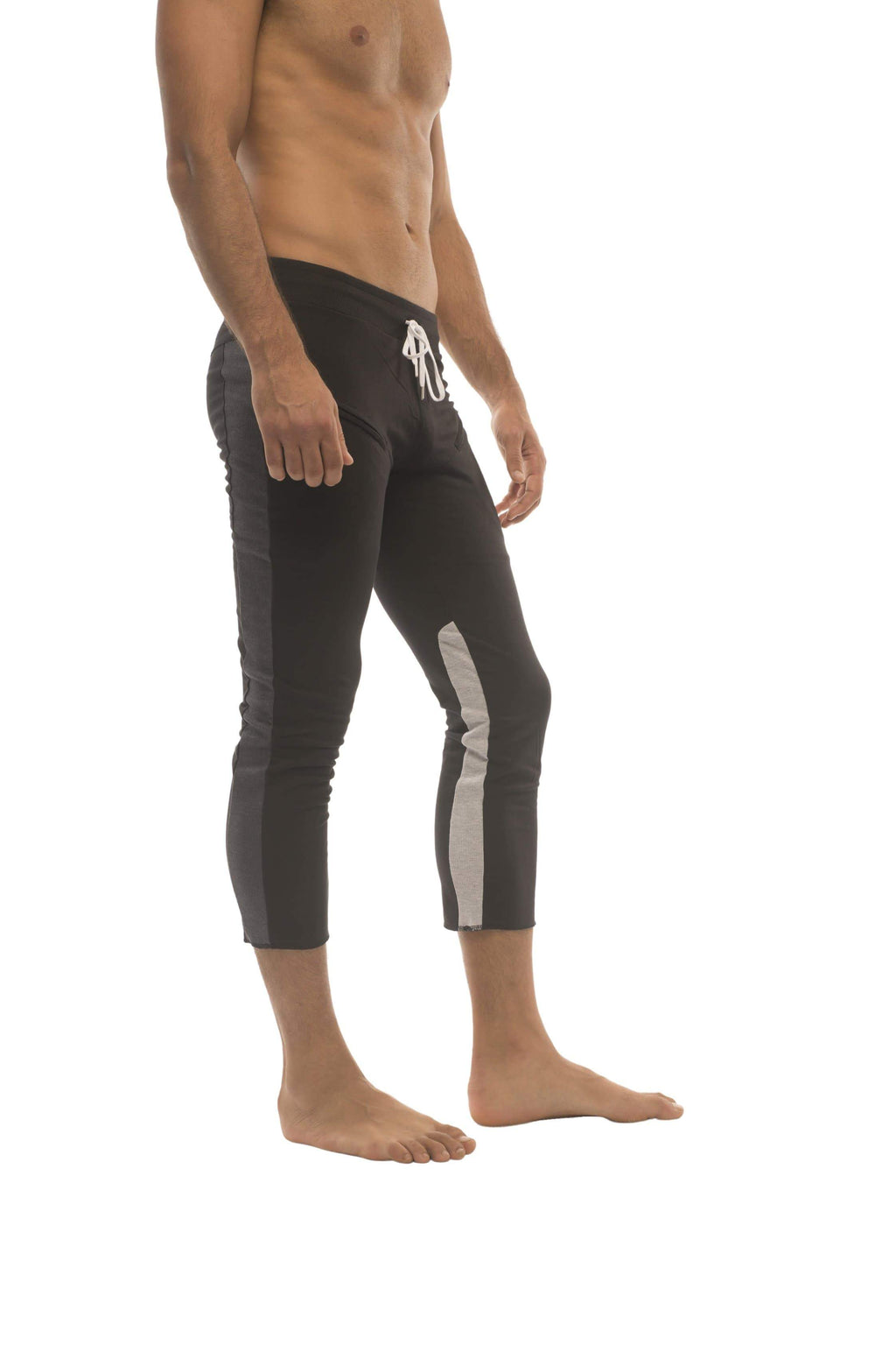 Mens black capri-length swim trunks with gray side panels and white logo on waistband featuring zipper pockets