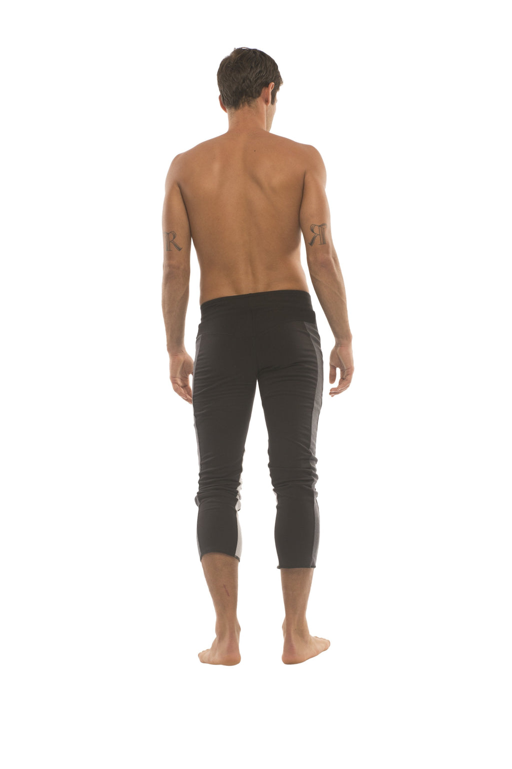 Mens black capri yoga pants with 4 5 zipper pockets and subtle charcoal and grey side stripes in a sleek fit