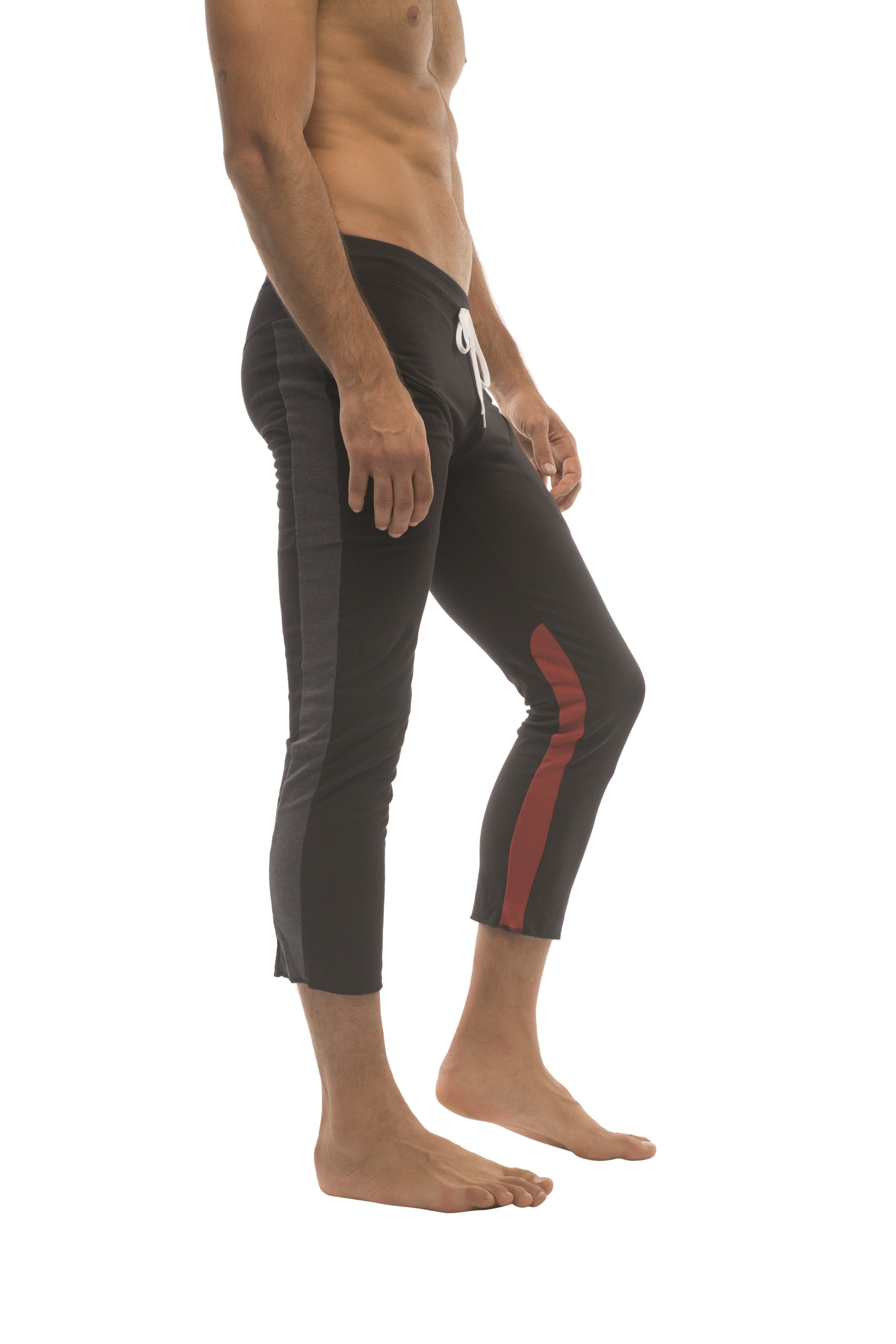 Mens 4/5 zipper pocket capri yoga pants in black with charcoal and red side stripe and white drawstring waistband