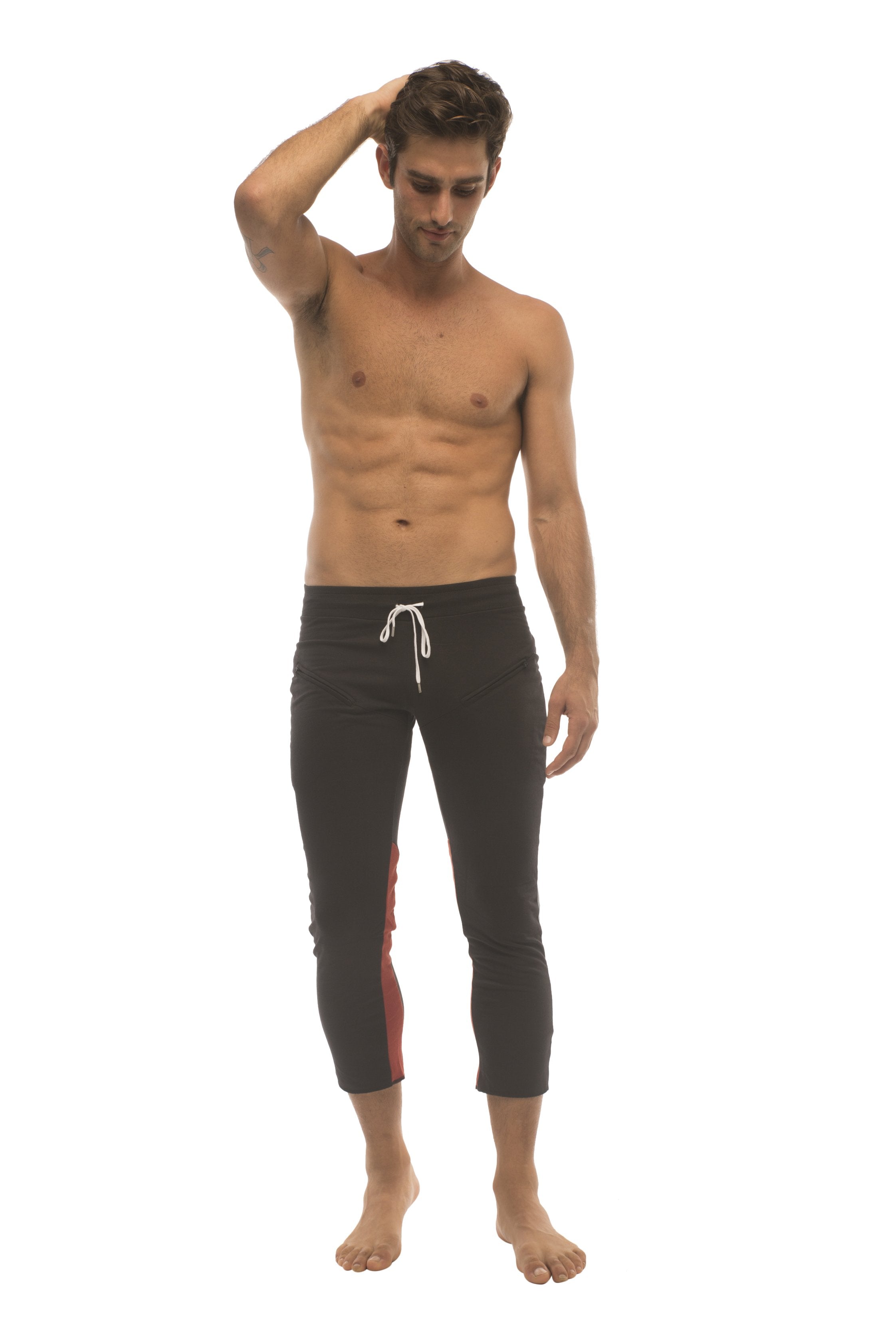 Mens 4/5 zipper pocket capri yoga pants in black with charcoal and red featuring black capri swim trunks with white drawstring and red side panels
