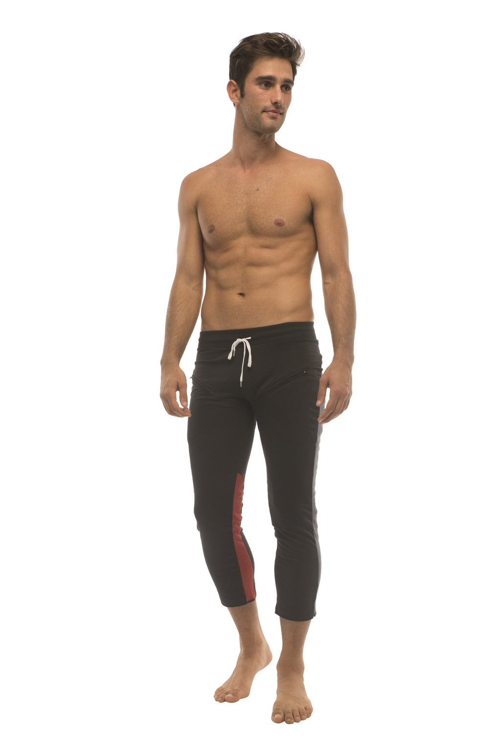 Mens black capri yoga pants with red side stripe, white drawstring waistband, and zipper pockets for athletic use