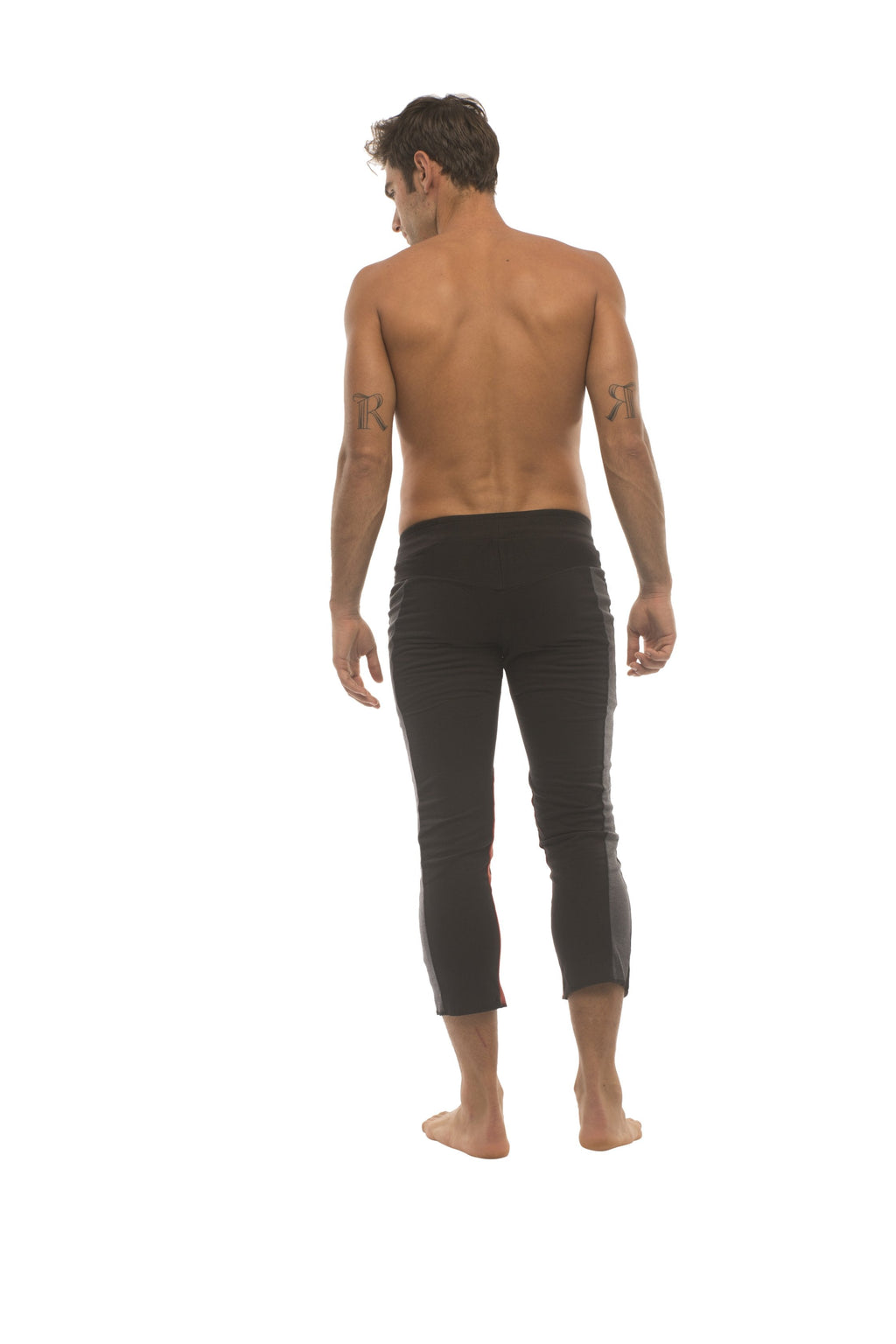 Mens black capri yoga pants with a sleek form-fitting design and charcoal and red zipper pockets