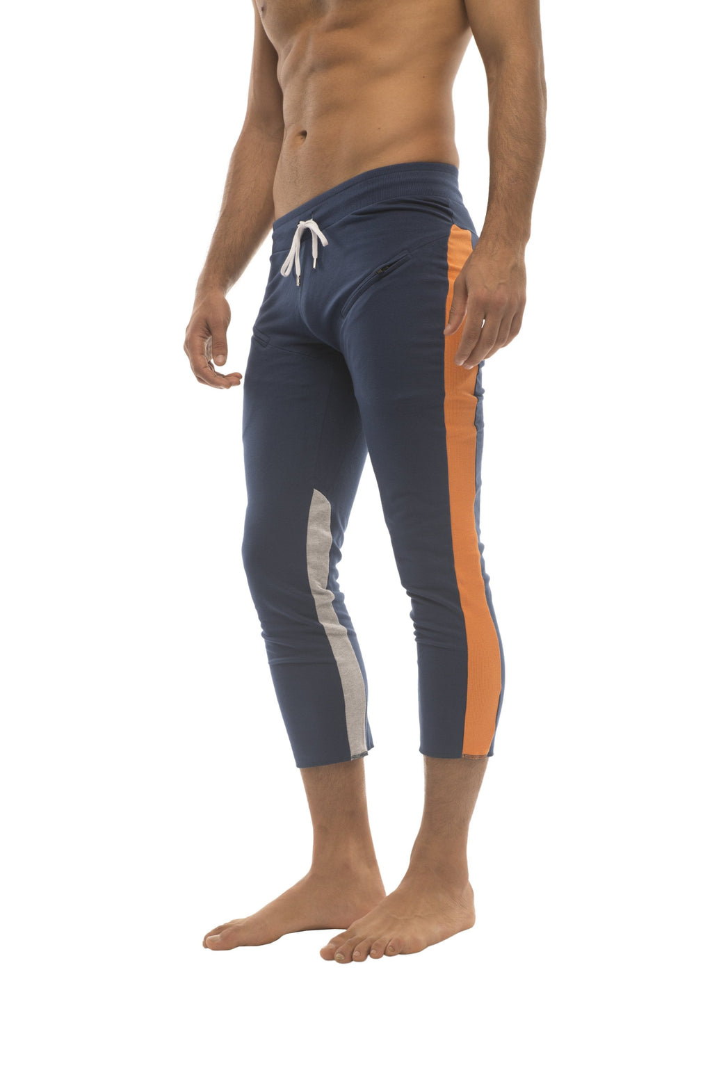 Mens navy blue athletic capri yoga pants with orange and white side stripes and a 4/5 zipper pocket