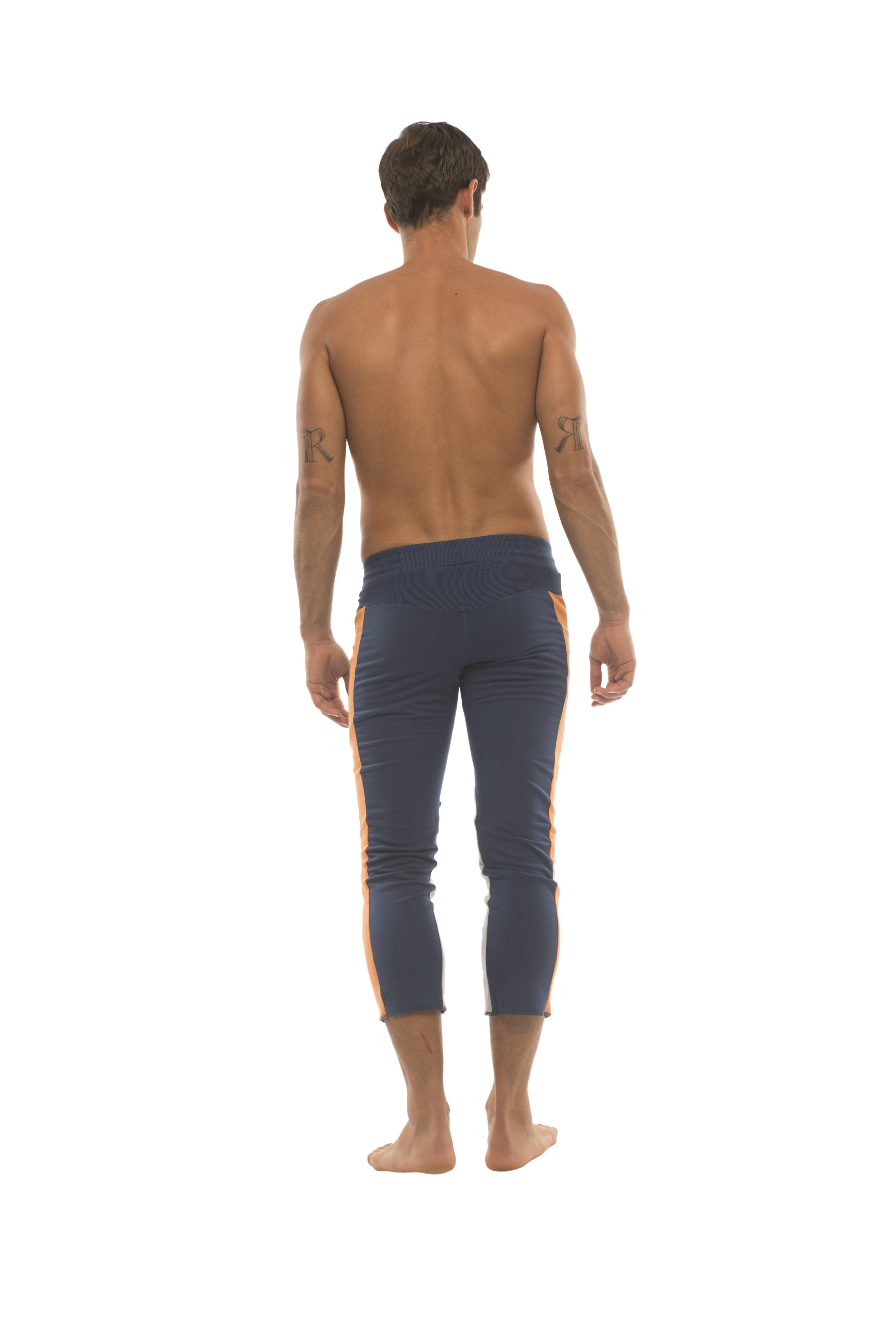 Mens navy blue capri yoga pants with orange side stripes and 4/5 zipper pockets for comfortable activewear