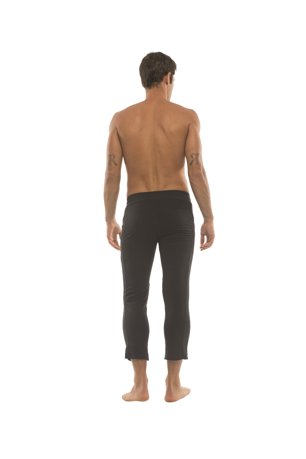 Mens solid black capri yoga pants with a snug fit and smooth stretchy fabric featuring 4/5 zipper pockets