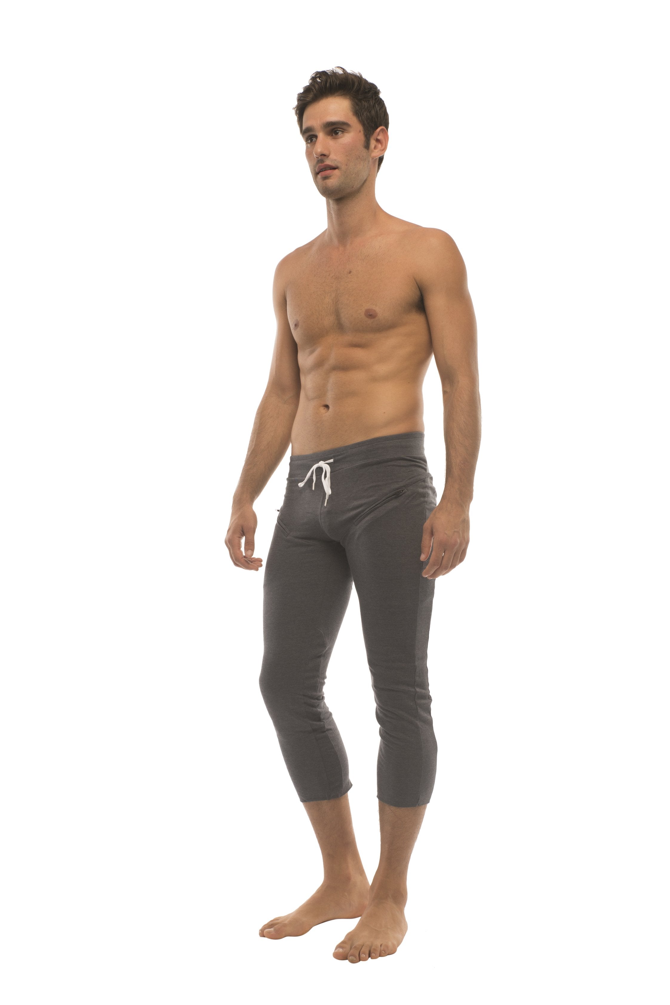 Dark gray mens capri-length yoga pants with white drawstring waistband and zipper pockets in solid charcoal color