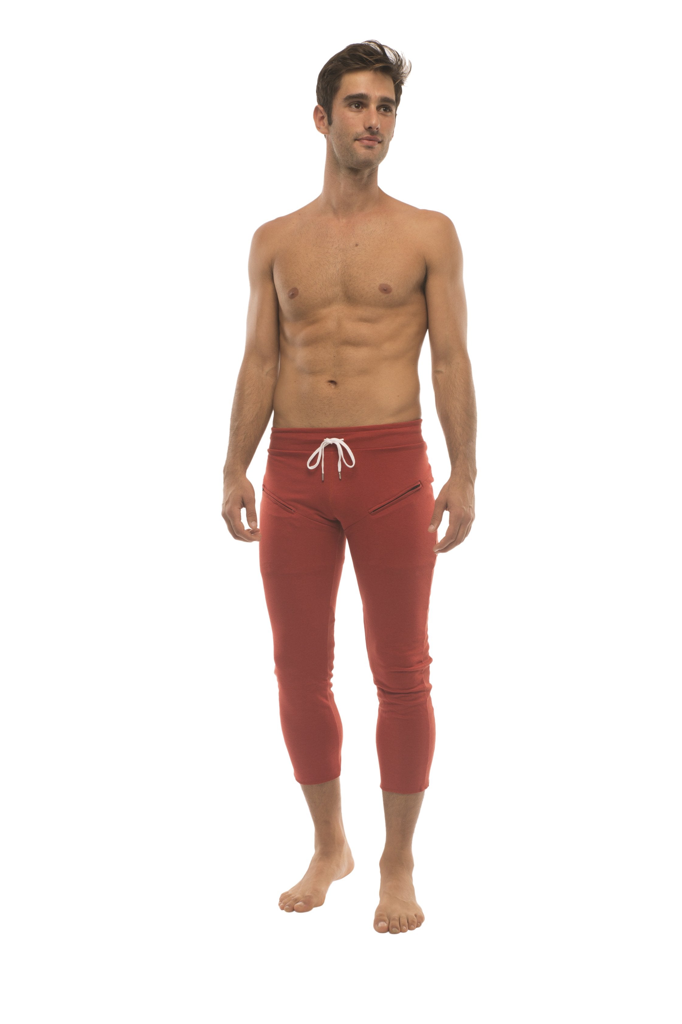 Mens cinnabar red capri yoga pants with white drawstring waistband and side zipper pockets for activewear