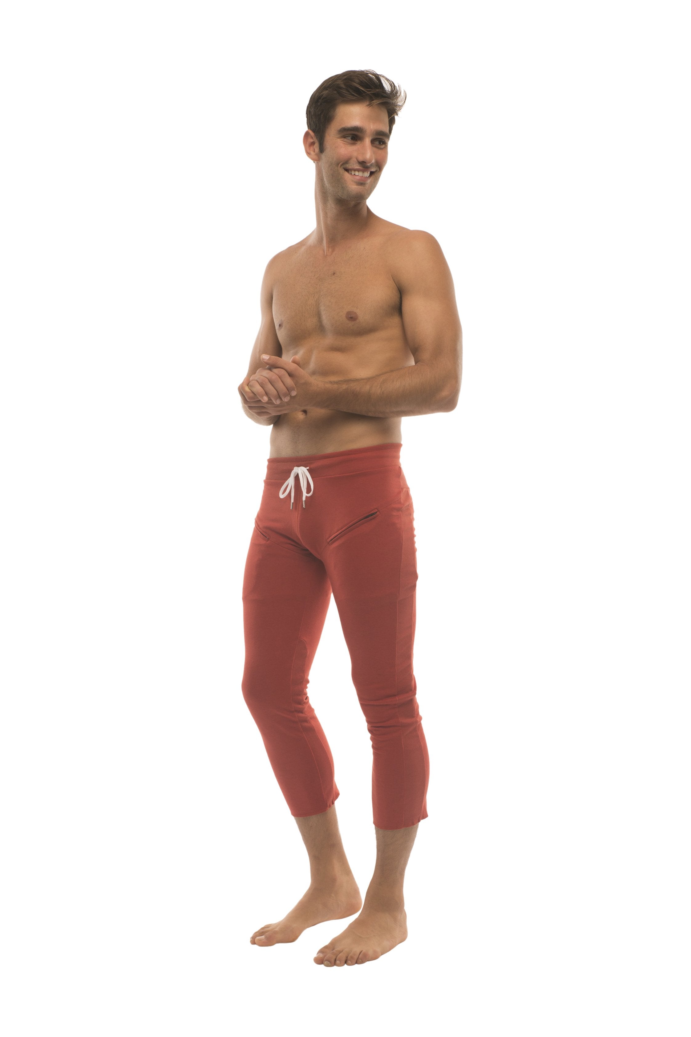 Mens 4/5 zipper pocket capri yoga pants in solid cinnabar red with white drawstring waistband and side pockets