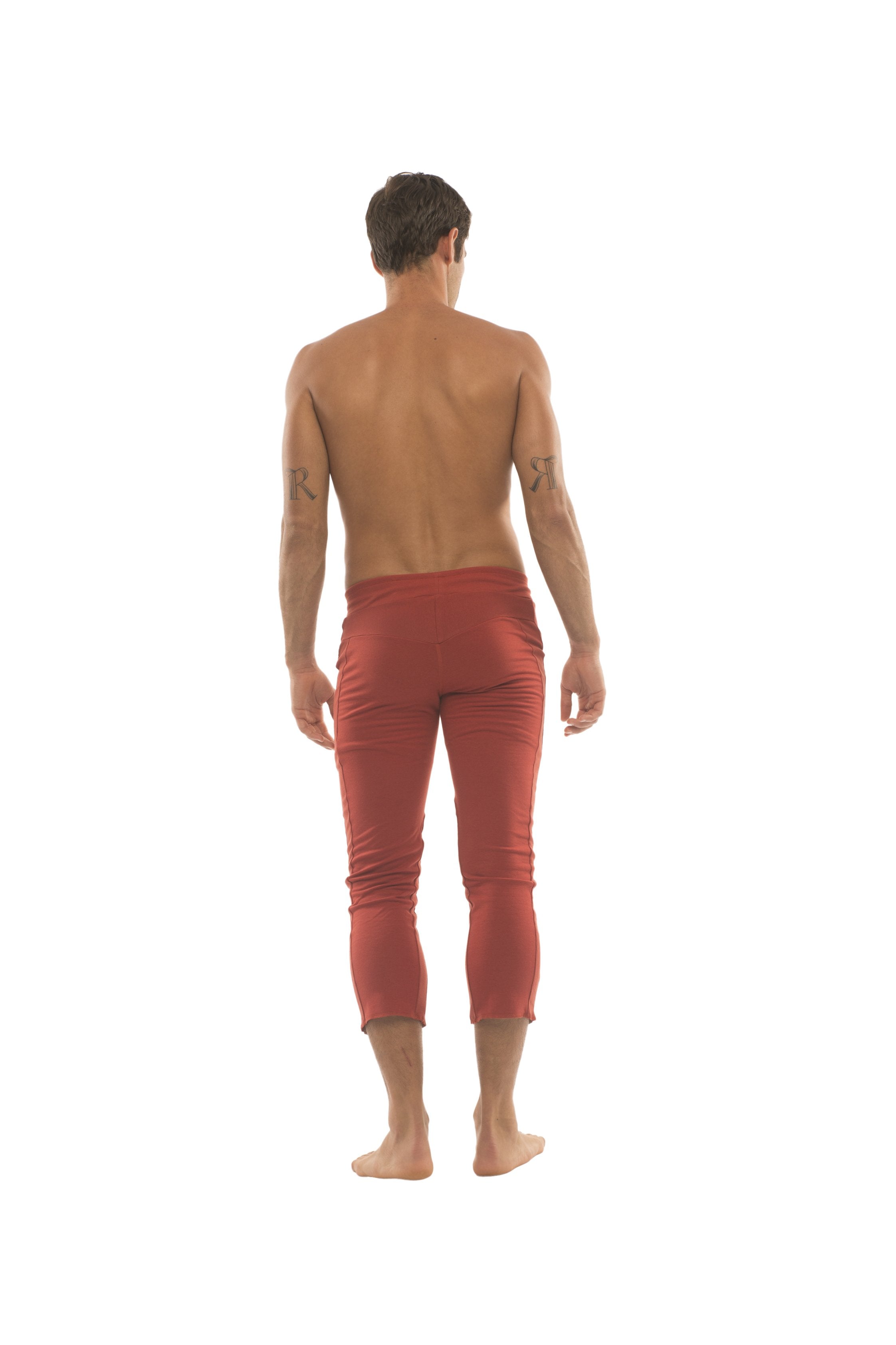 Mens 4 5 zipper pocket capri yoga pants in solid cinnabar red with smooth slightly reflective rust red fabric