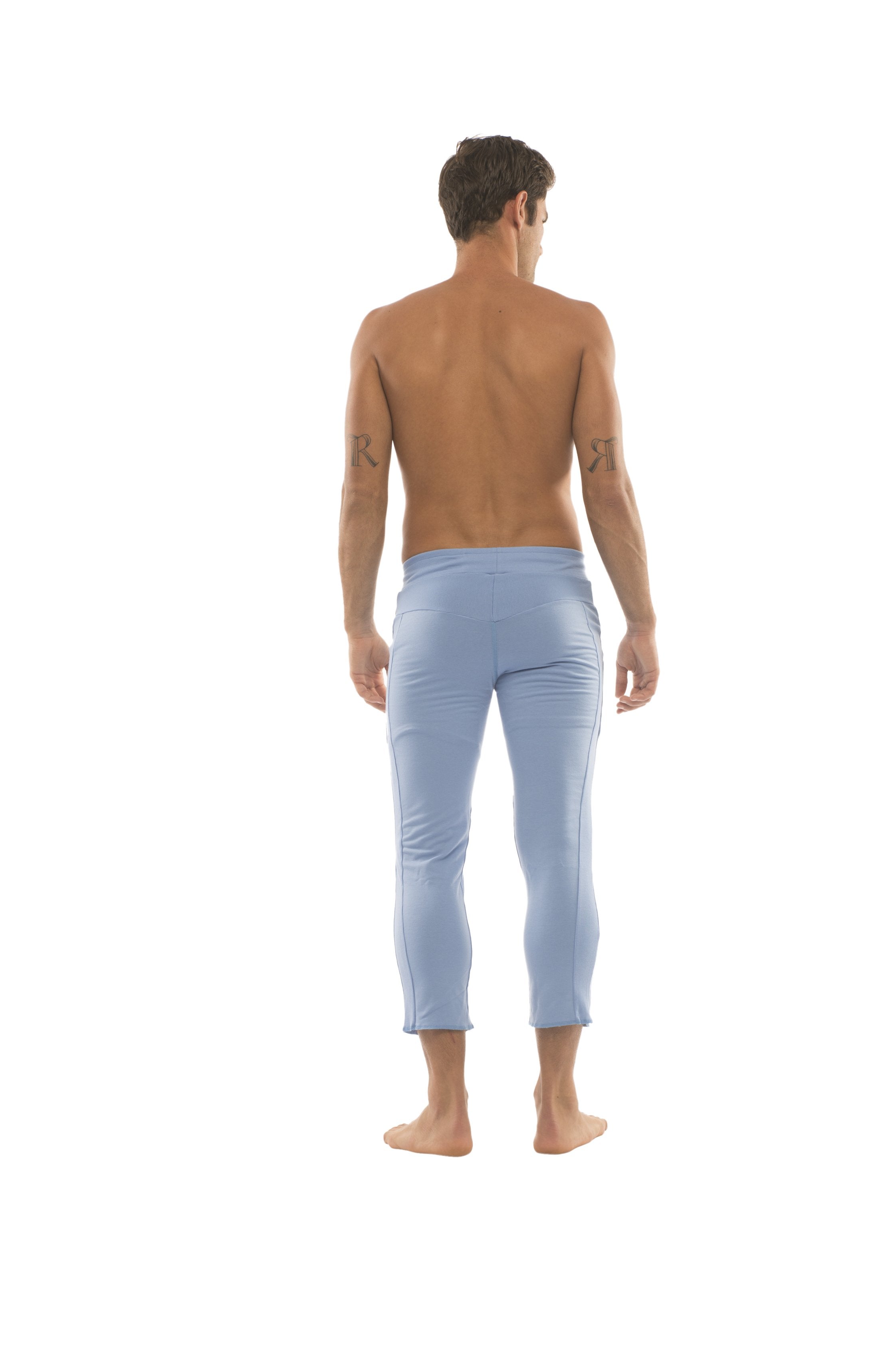 Light blue form-fitting mens 4/5 zipper pocket capri yoga pants with smooth fabric finish in solid ice blue