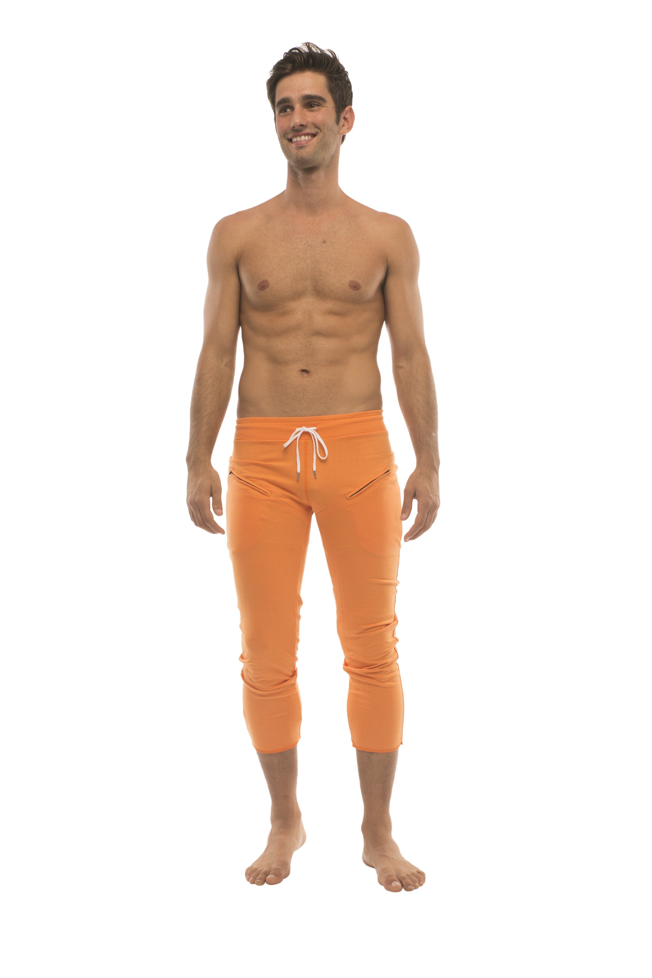 Orange capri-length mens yoga pants with white drawstring waistband and zipper pockets for athletic use