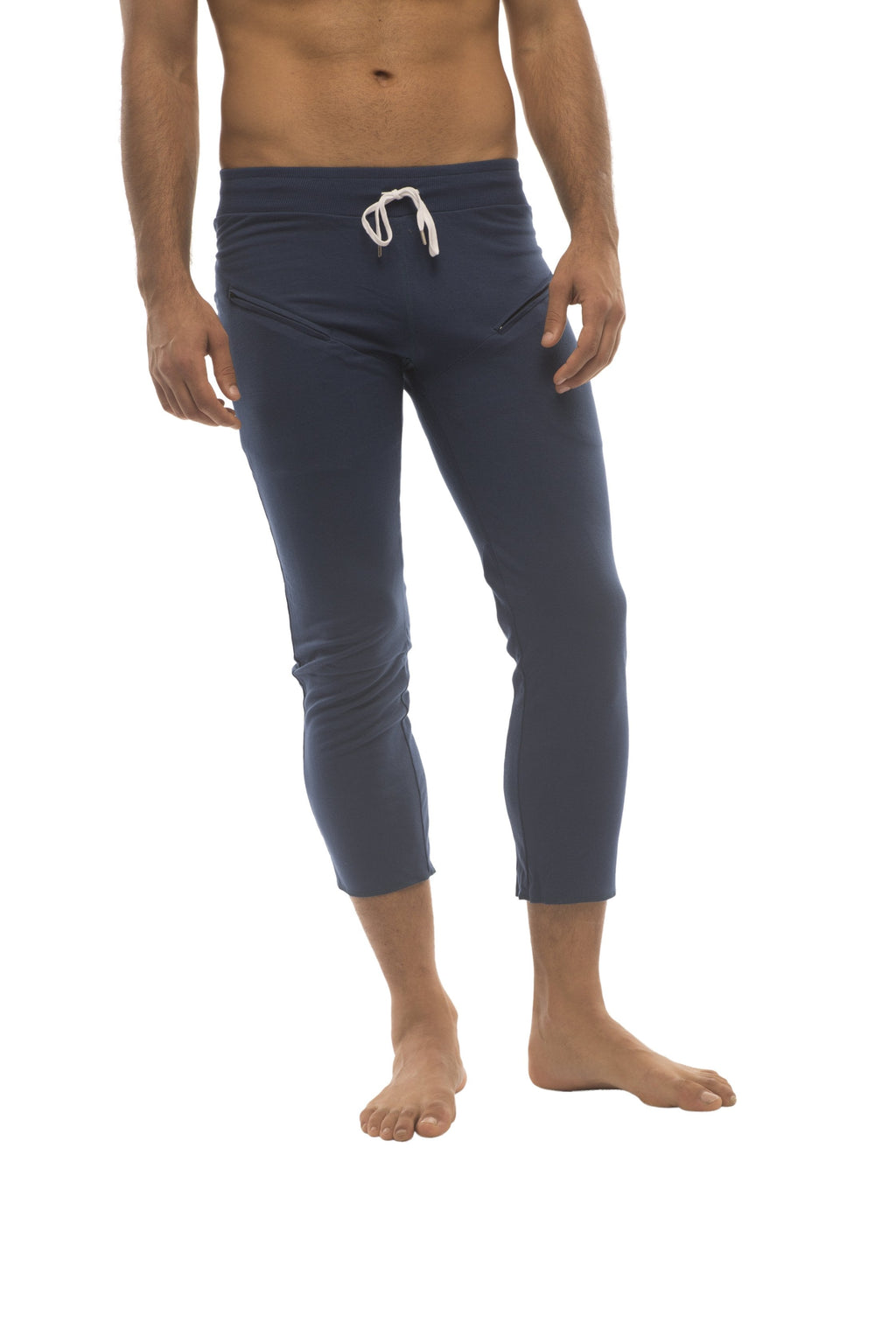 Mens solid royal blue capri yoga pants with white drawstring waistband and zipper pockets in navy blue
