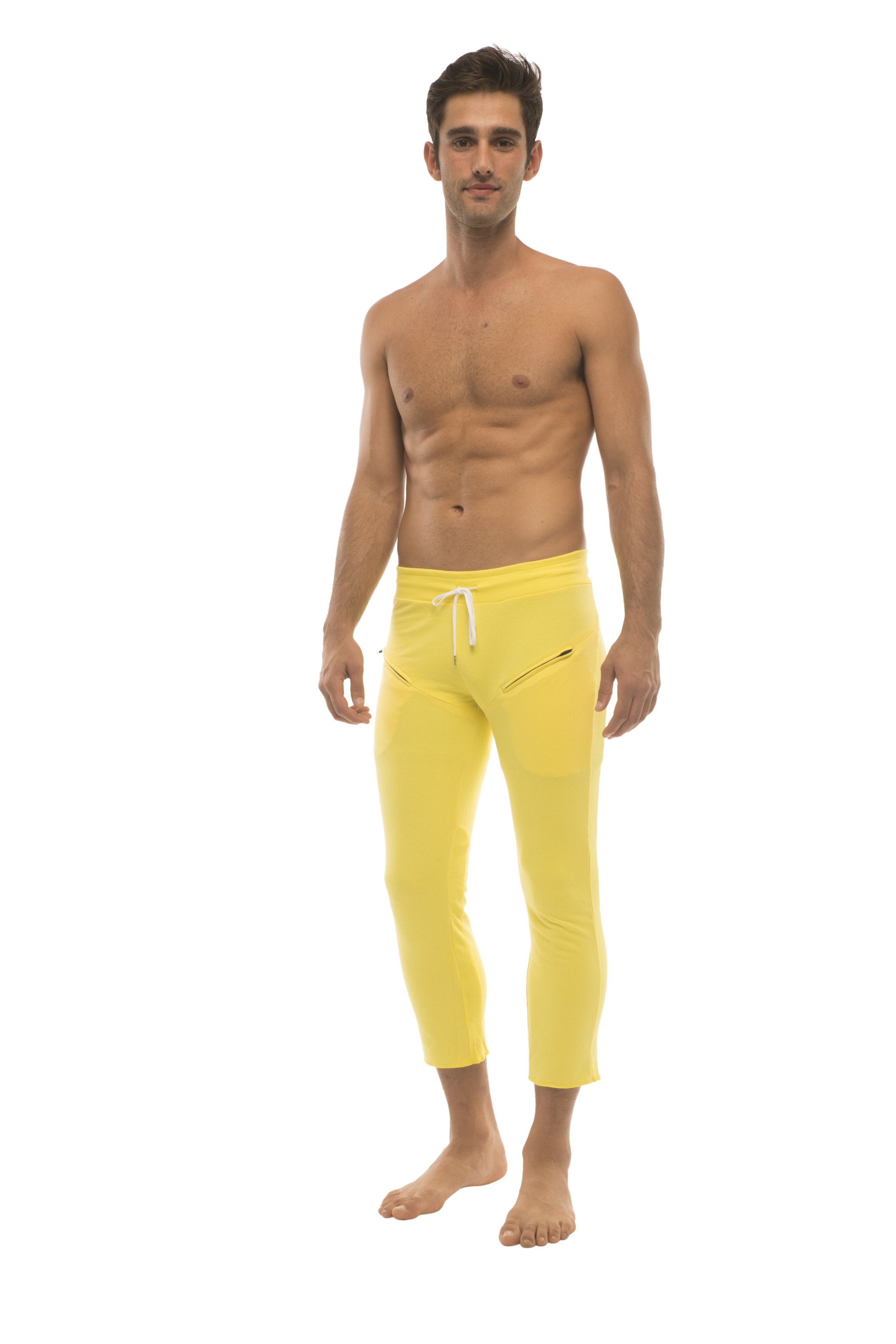 Mens solid yellow 4/5 zipper pocket capri yoga pants with bright yellow cropped jogger style and white drawstring waistband