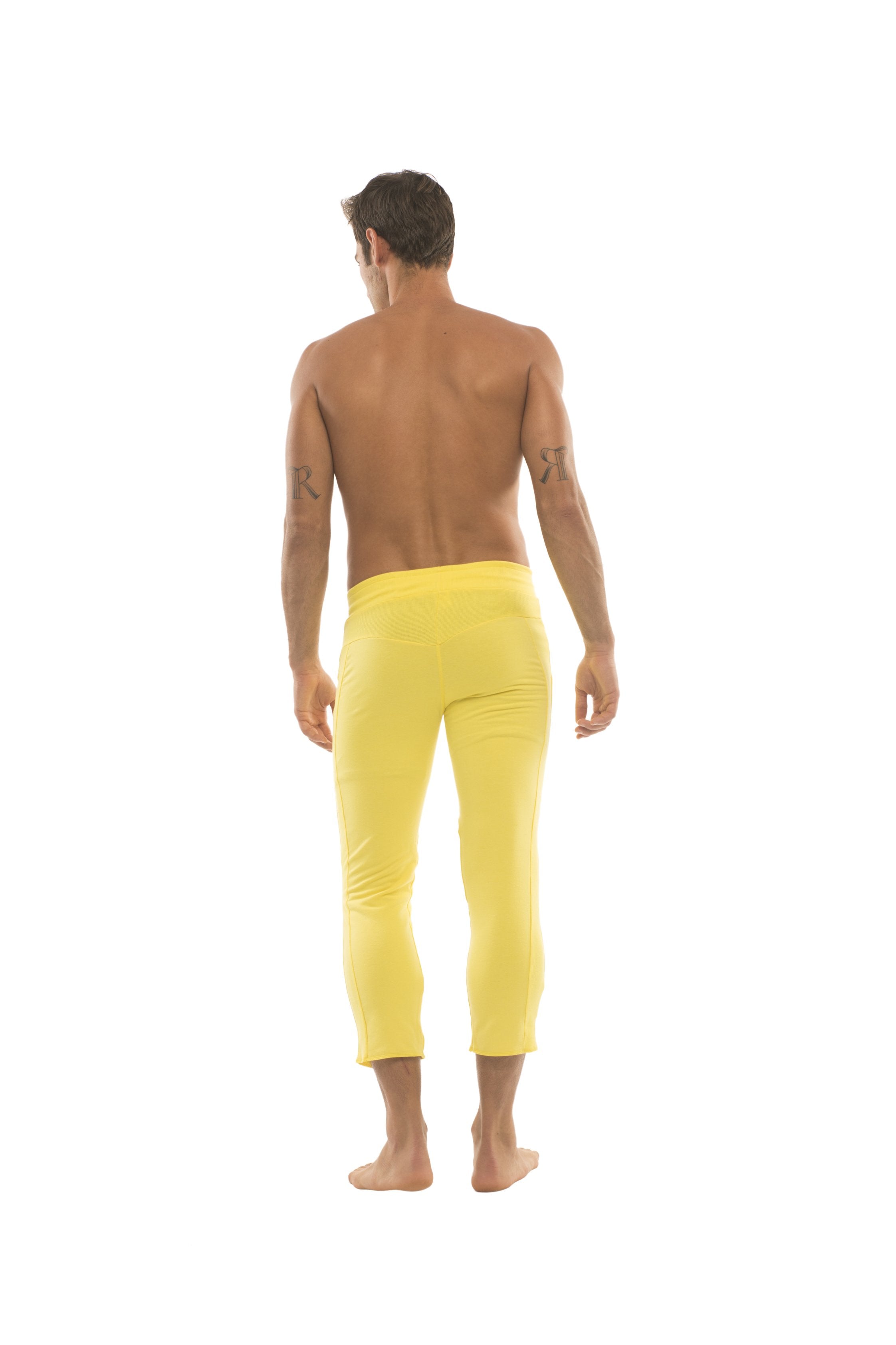 Mens solid yellow capri yoga pants with 4 5 zipper pockets in bright yellow form-fitting fabric