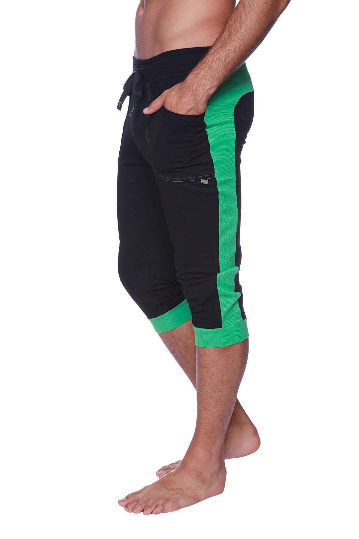 Mens cuffed yoga pants in black with green featuring a drawstring waistband side pockets and ribbed cuffs