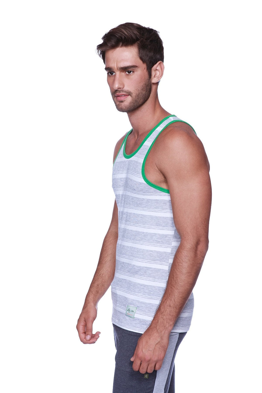 Men’s gray and white striped tank top with green neckline trim paired with charcoal heather gray cuffed yoga pants
