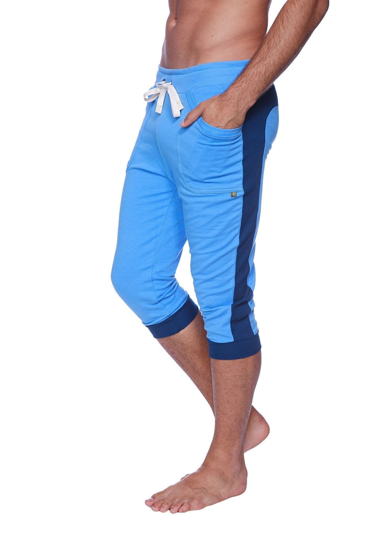 Mens cuffed yoga pants in ice blue and royal blue with a white drawstring waistband and athletic capri fit