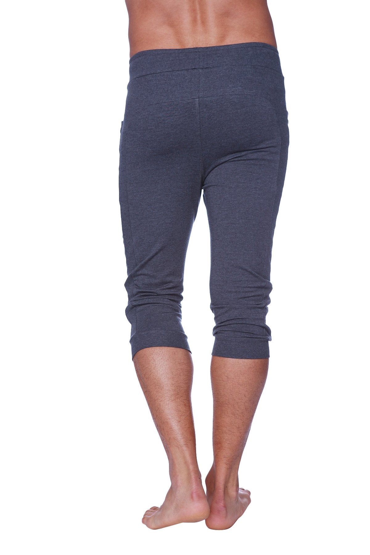Mens cuffed yoga pants in solid charcoal made of stretchy dark gray fabric with a high waistband and rolled cuffs