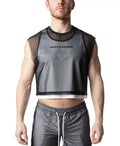 A model wears a sheer black crop top layered over white, with mesh cap sleeves and text on the chest.