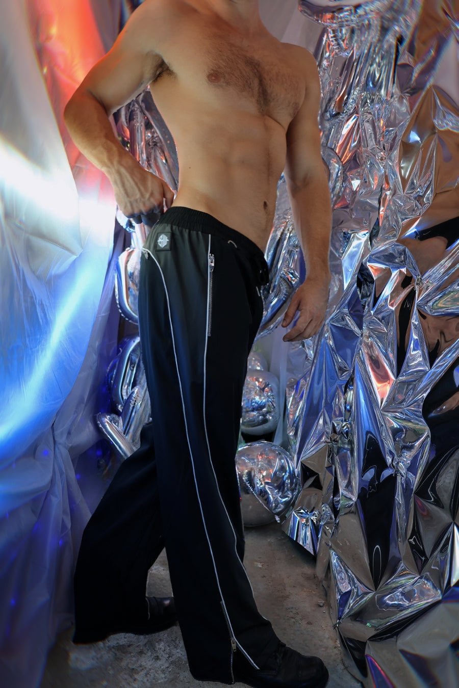 Black NSA track pants featuring white zipper accents down the sides for athletic and casual wear