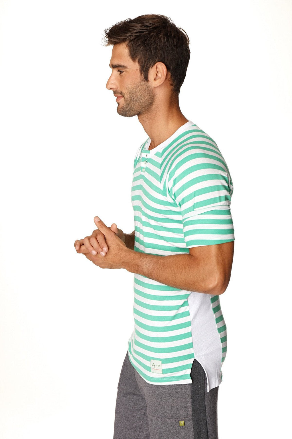 A man wearing a teal and white striped short-sleeved nautical raglan resort henley tee with crew neck