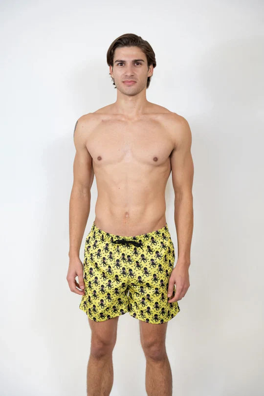 Bright yellow swim shorts with a repeating black octopus pattern perfect for beach and pool use
