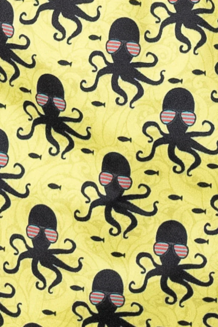 Yellow octopus print swim short featuring black octopuses with striped sunglasses and small fish on fabric