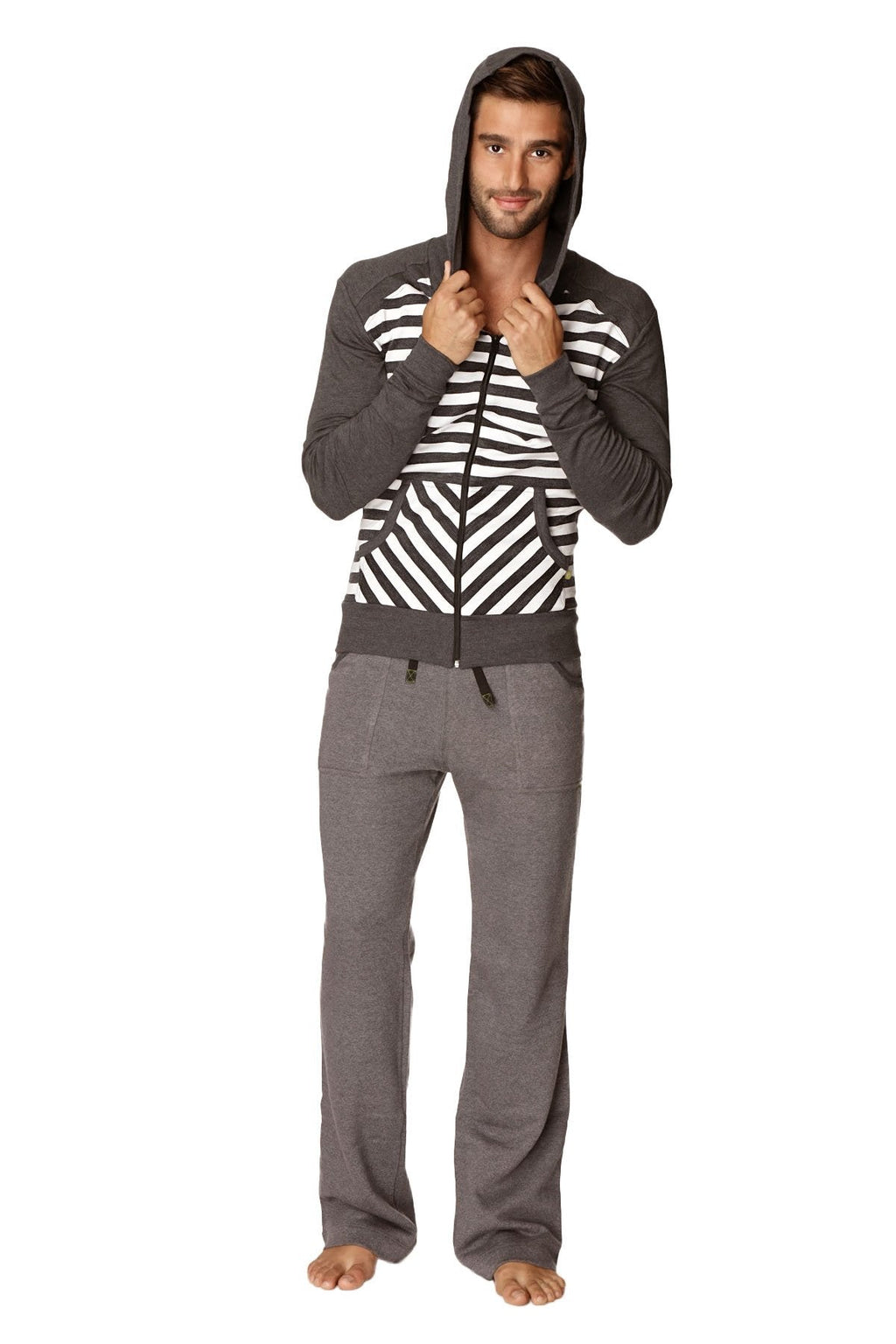 A man wearing a charcoal stripe original limited edition form-fit crossover yoga track performance fleece hoodie with matching pants
