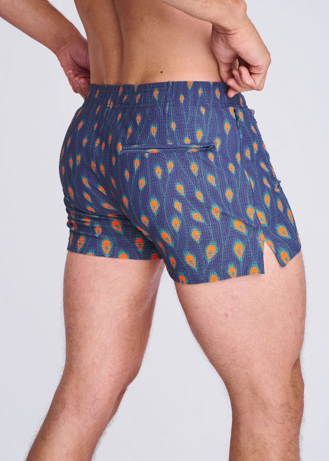 Blue peacock feathers seersucker swim shorts with vibrant orange and teal feather pattern elastic waistband and side slit