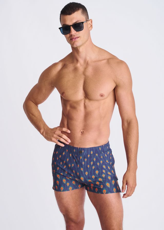 Blue swim trunks with orange and yellow feather pattern made of seersucker with mesh lining for swimming