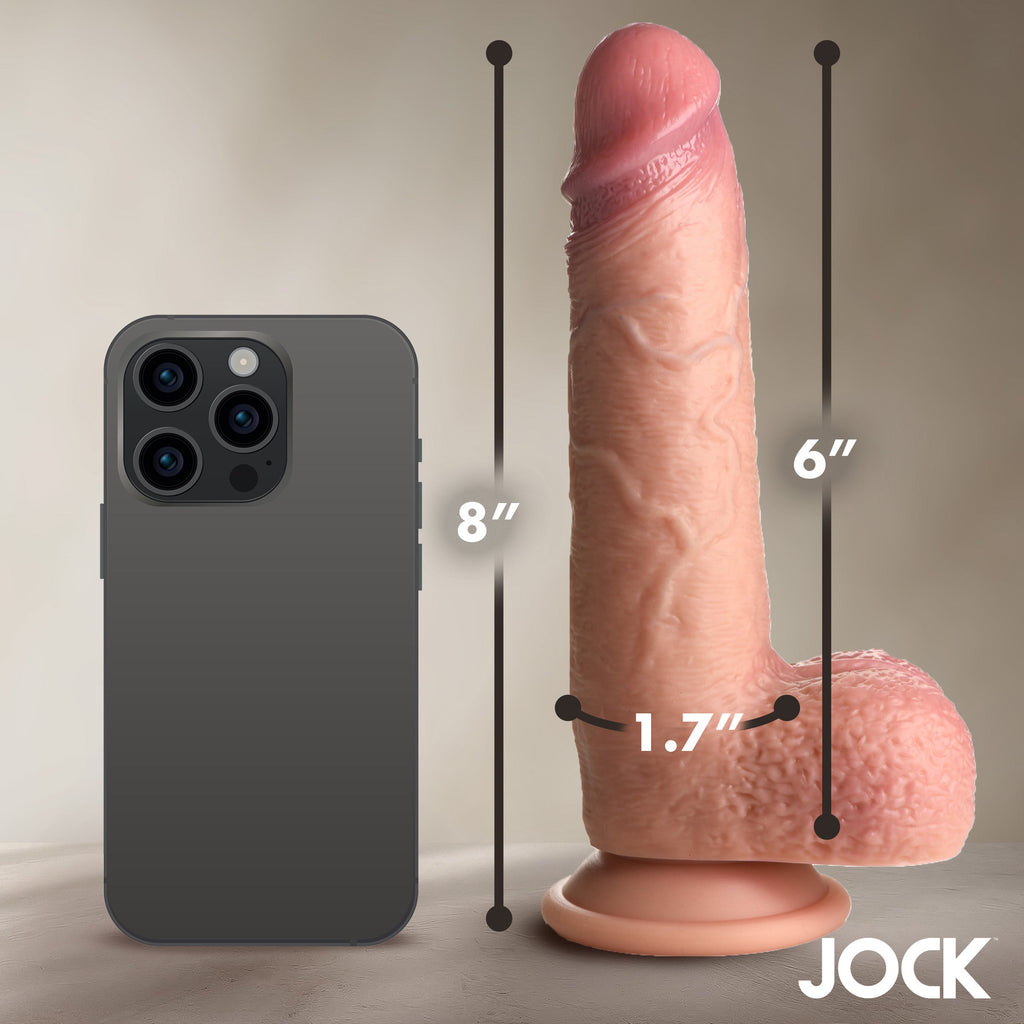 Curve Toys JOCK silicone dildo in skin tone next to a smartphone for scale, showing dimensions and realistic texture.