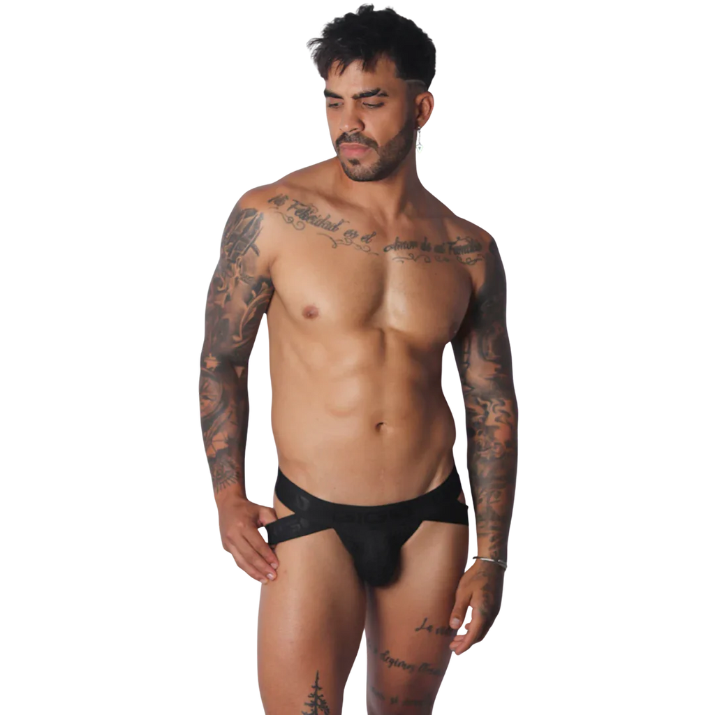 Black Gigo jockstrap featuring a wide branded elastic waistband and cutout side details on a tattooed male model.