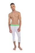 White capri-length performance yoga leggings in arctic white with a bright green elastic waistband and compression fit