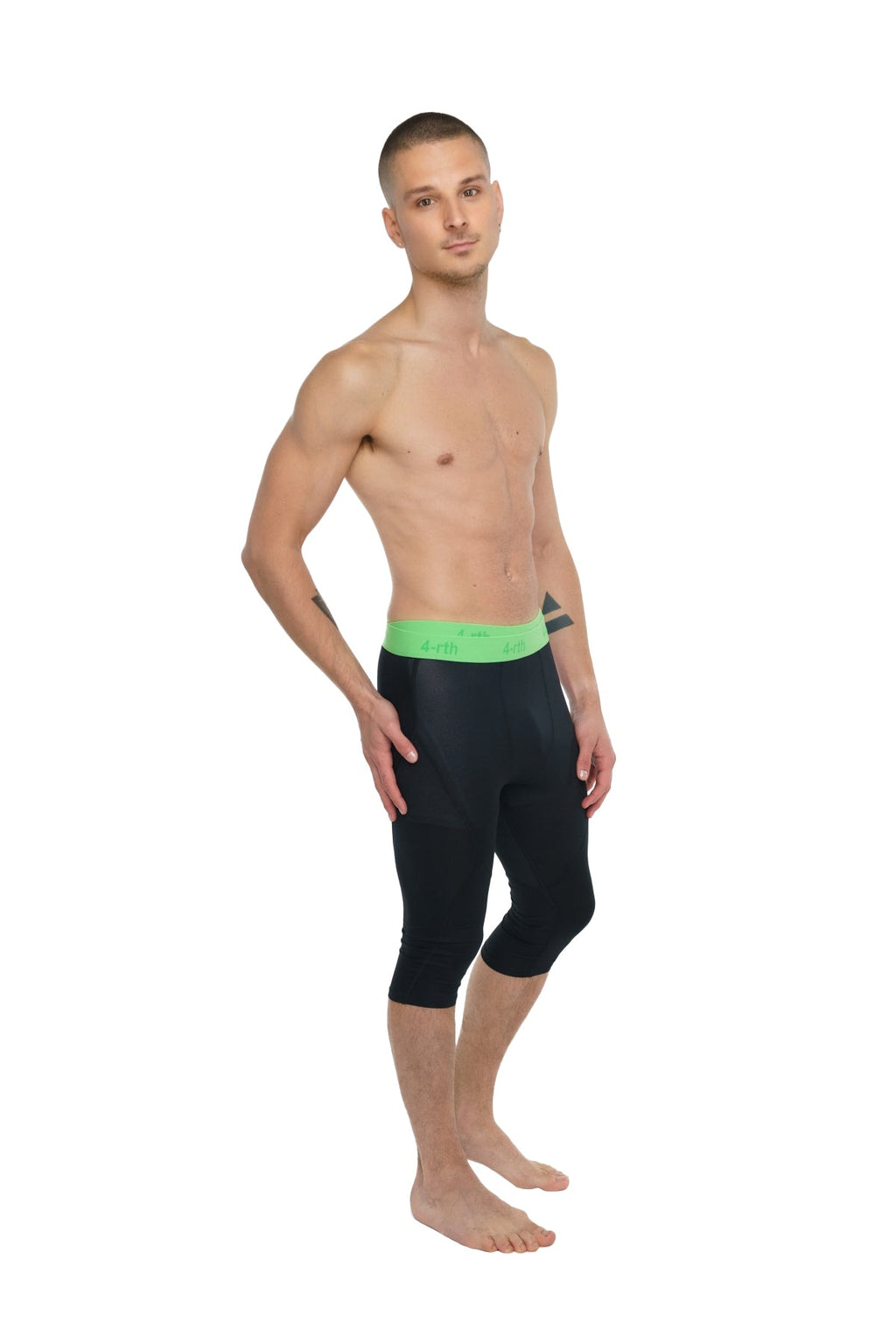 Performance yoga leggings 3/4 in carbon black with a bright green waistband and capri-length fit for active wear