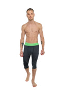 Performance yoga leggings 3/4 in charcoal heather featuring black compression fabric with a bright green waistband