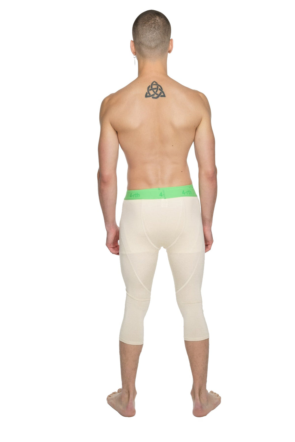 Cream-colored performance yoga leggings 3/4 with bright green elastic waistband and form-fitting capri length