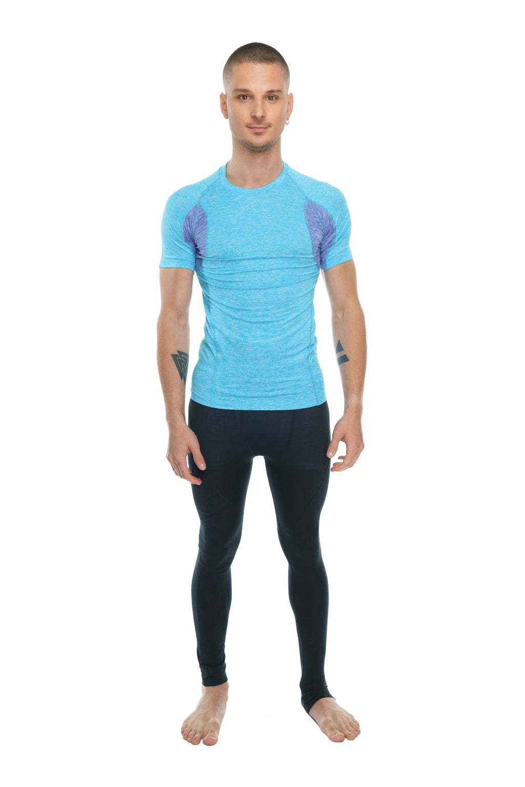 Light blue short-sleeved athletic shirt with purple wing-like shoulder patterns paired with carbon black performance yoga leggings long