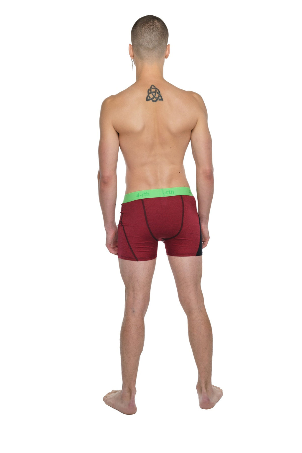 Red athletic briefs with a bright green waistband designed for performance yoga and active wear