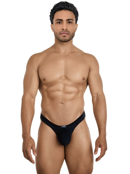 Man wearing a sleek black Pikante Isis thong, designed for seductive comfort with a smooth, minimalist aesthetic.
