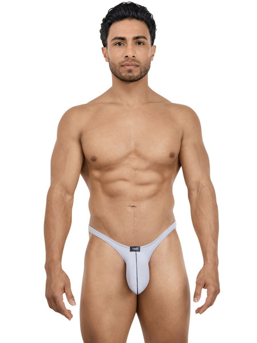 A model wears a sleek, gray Pikante Neftis men’s bikini brief featuring thin side straps for minimal coverage.