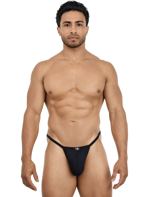 A man wearing a sleek black Pikante Khonsu thong crafted from smooth, minimalist fabric for men's intimate wear.