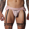 Romantic pink lace Gigo jockstrap with frilled edges, branded elastic waistband, and black adjustable leg garters.