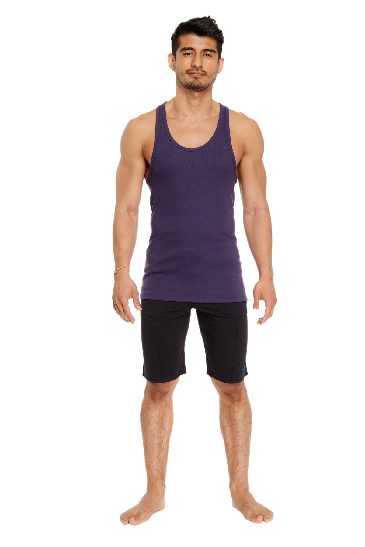 A man wearing a solid eggplant purple racer-back yoga tank with a sleeveless design and rounded neckline